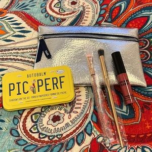 Ipsy bag with eyeshadow and two eyeshadow brushes never used. And lipstick.